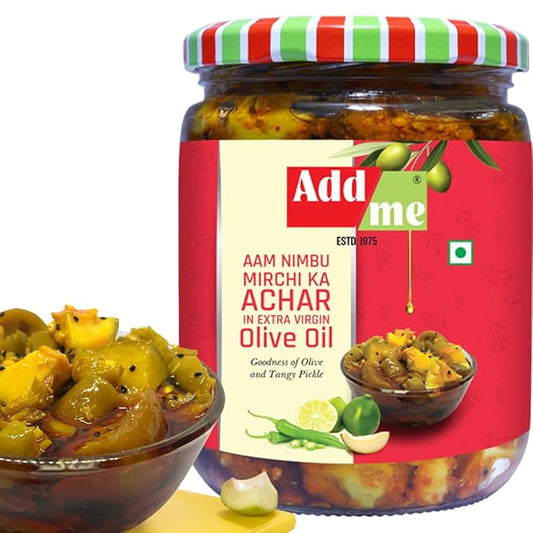 Jar of Add Me Aam Nimbu Mirchi Ka Achar with a bowl of pickle and ingredients on a white background