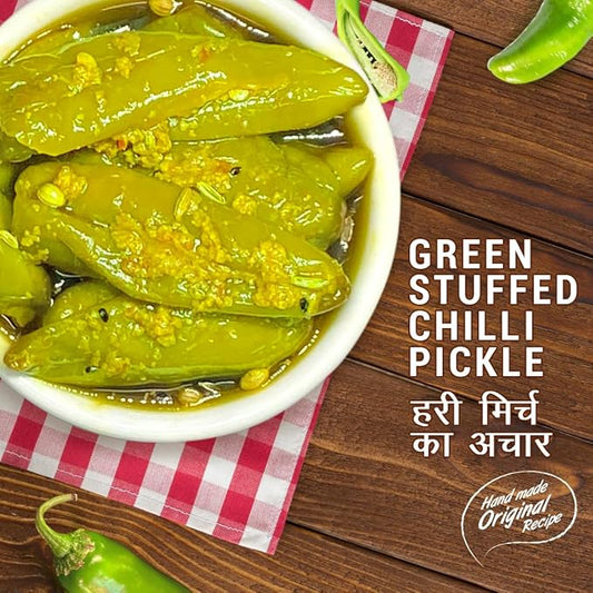 Green stuffed chilli pickle in a bowl on a wooden surface with text and logo.