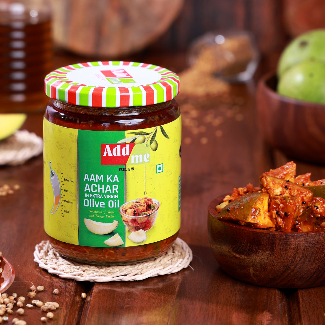Add Me Foods: Jar of Adda Me Aam Ka Achar on a wooden table with ingredients around