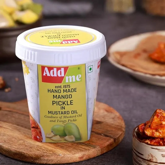 Add me hand made mango pickle container on a wooden board with food items in the background