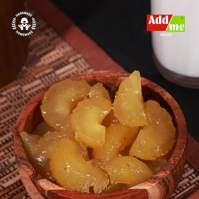 Add Me Foods: Wooden bowl filled with preserved fruit (Amla) pieces on a textured surface with 'Add me' branding.