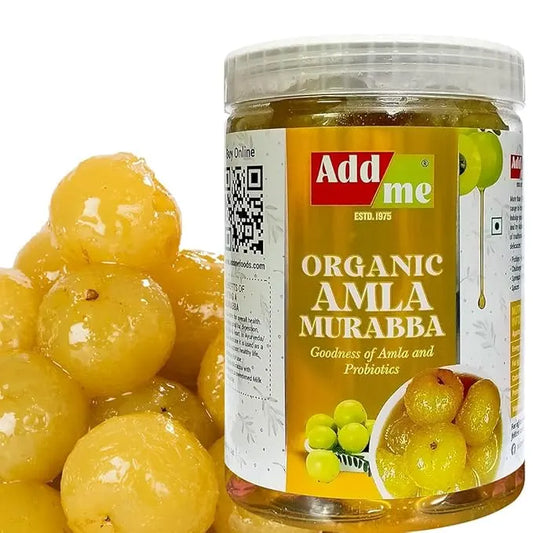 Jar of Add Me Organic Amla Murabba with a pile of yellow fruits on a white background