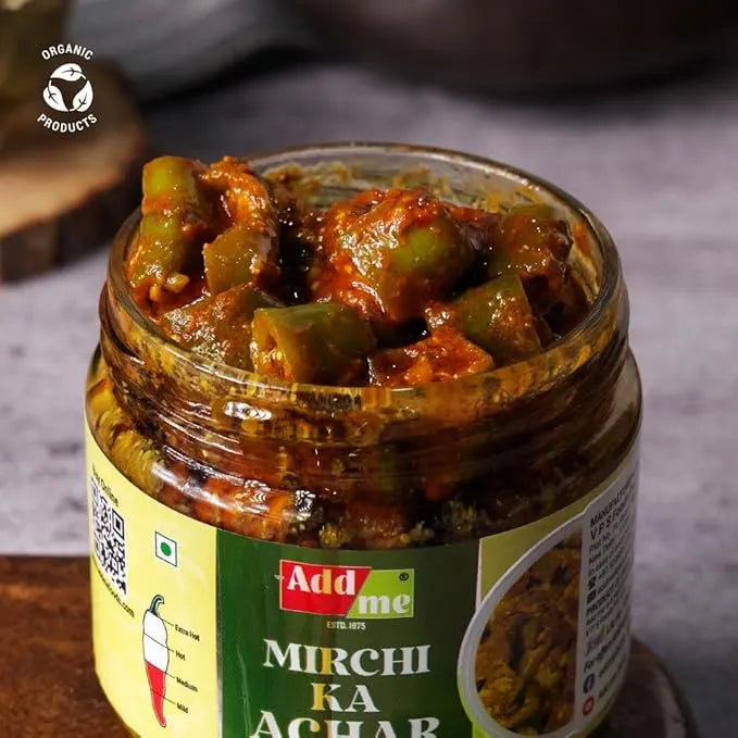 Jar of Mirchi Ka Achar with 'Add Me' label on a wooden surface