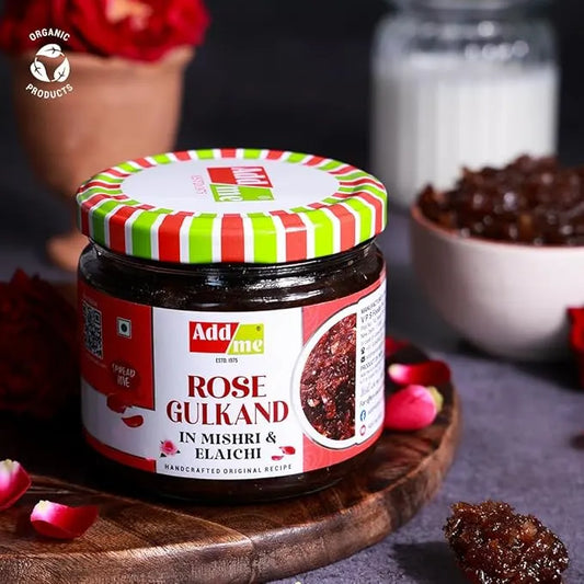 Add Me Foods: Jar of Addme Rose Gulkand on a wooden board with flowers and a blurred background