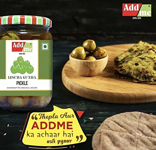 Jar of Addme pickle with a wooden board with pickles and a flatbread in the background.