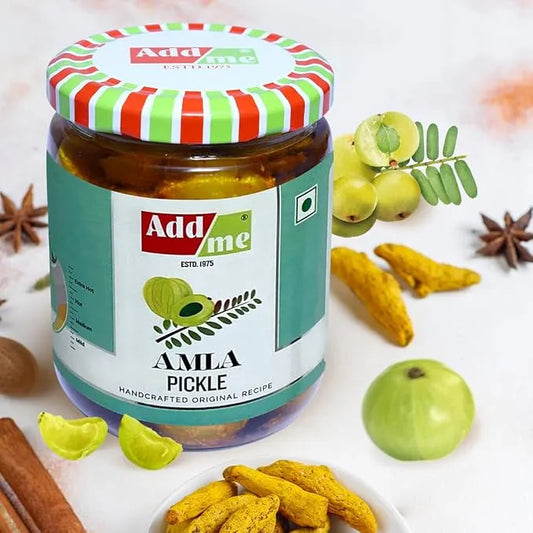 Jar of Add Me Amla Pickle with ingredients on a white background