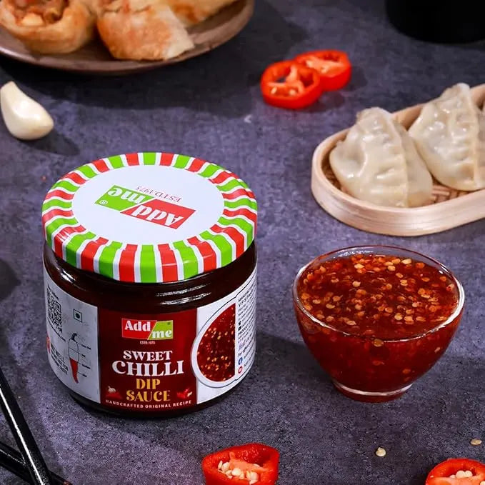 Add Me Foods: Jar of Add some Sweet Chilli Dip Sauce with a bowl of sauce and food items on a dark surface