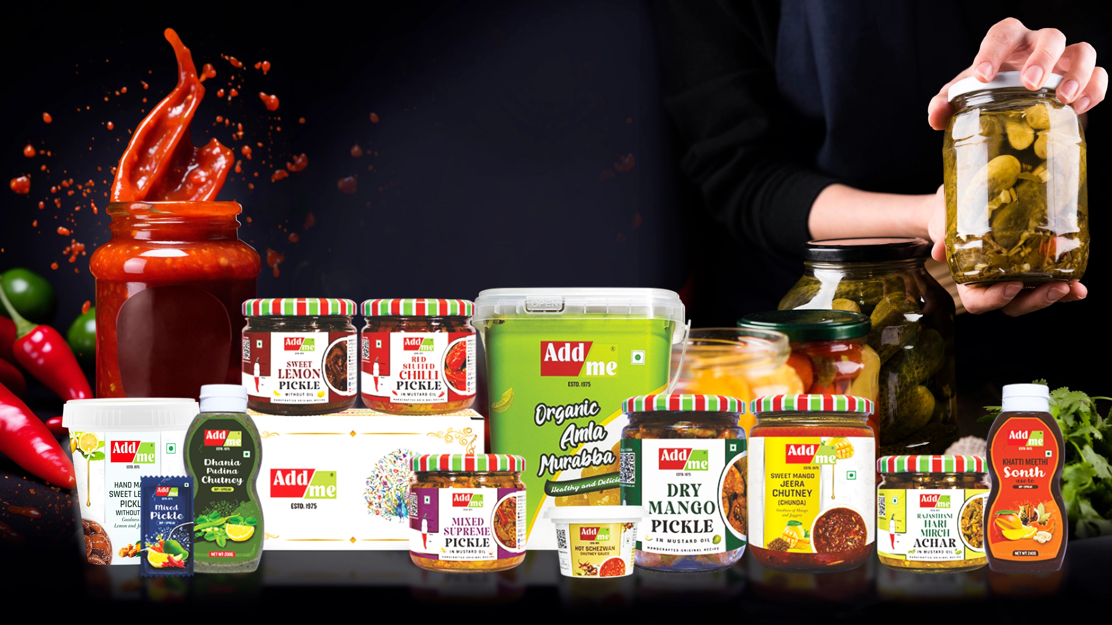 Add Me assorted pickles and condiments with a hand holding a jar against a dark background