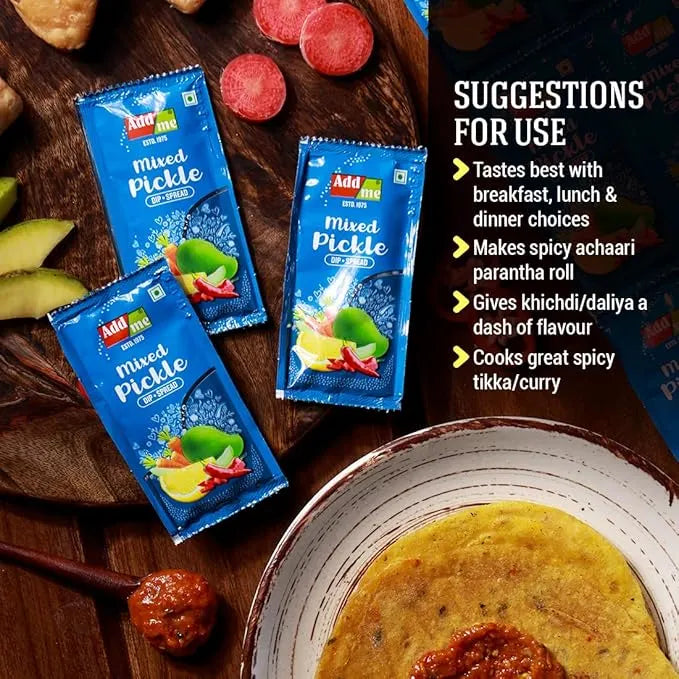 Three packets of Add Ma Mixed Pickle on a wooden board with food items and a bowl of food.