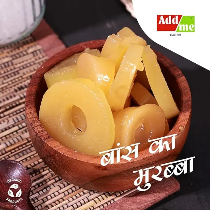 Wooden bowl with preserved plums on a textured surface, featuring Addme logo.