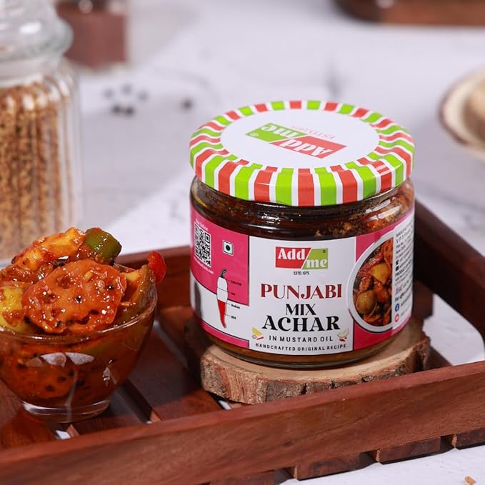 Jar of Punjabi Mix Achar with a colorful lid on a wooden tray