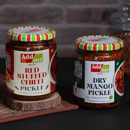 Two jars of pickles with colorful lids on a wooden surface.