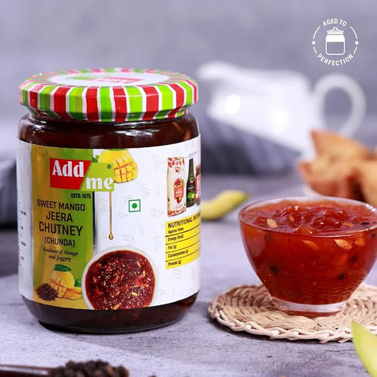 Jar of Add Me Sweet Mango Jeera Chutney with a bowl of chutney on a table.