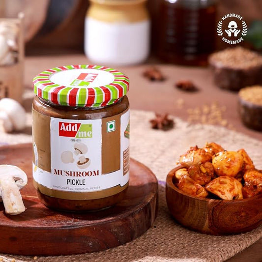 Jar of Add Me Mushroom Pickle on a wooden surface with snacks in the background