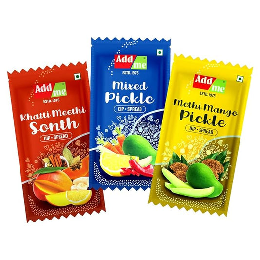 Three Add Me pickle packets in red, blue, and yellow on a white background