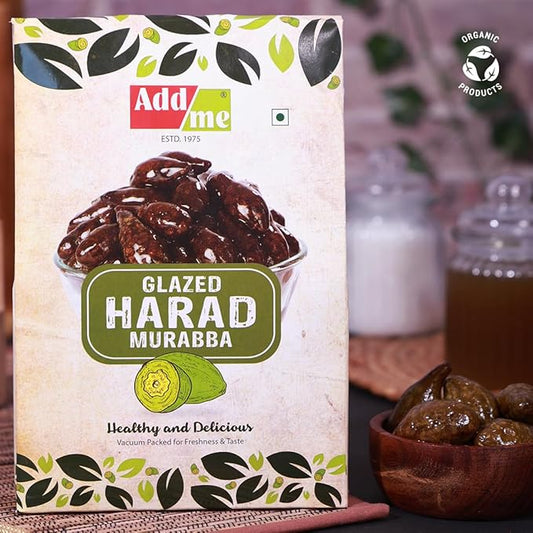 Add Me Foods: Packaging of Add Me Glazed Harad Murabba with a bowl of dried fruits in the background.