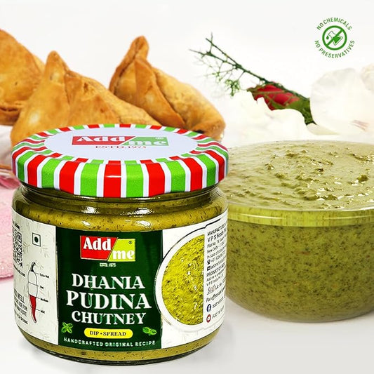Jar of Add Me Dhania Pudina Chutney with a bowl of chutney and samosas in the background.