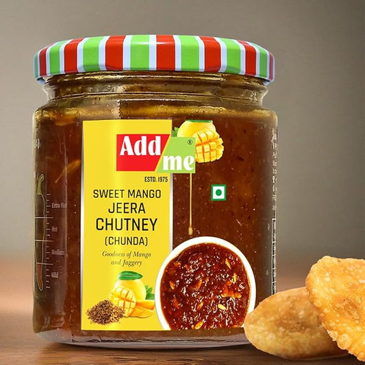Jar of Add Me Sweet Mango Jeera Chutney with crackers on a wooden surface