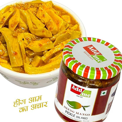 Bowl of hing mango pickle with Adda Me jar on a white background