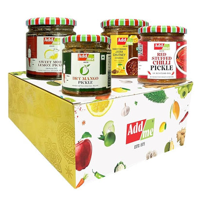 Four jars of Add Me pickles on a decorative box with fruit illustrations.