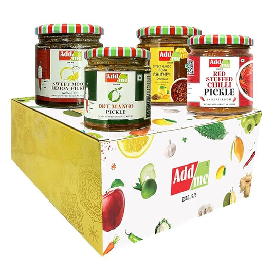 Four jars of Add Me pickles on a decorative box with fruit illustrations.