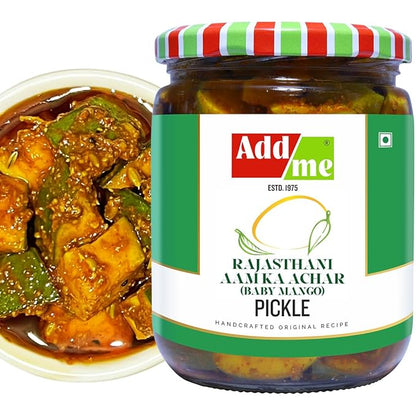 Jar of Add Me Rajasthani Aam Ka Achar pickle with a bowl of curry and green chilies.