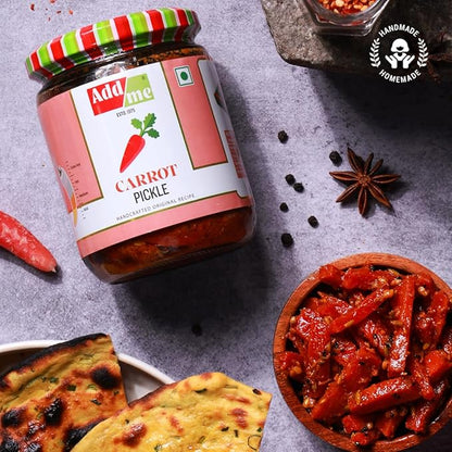 Jar of Add Me Carrot Pickle with spices and naan bread on a gray surface