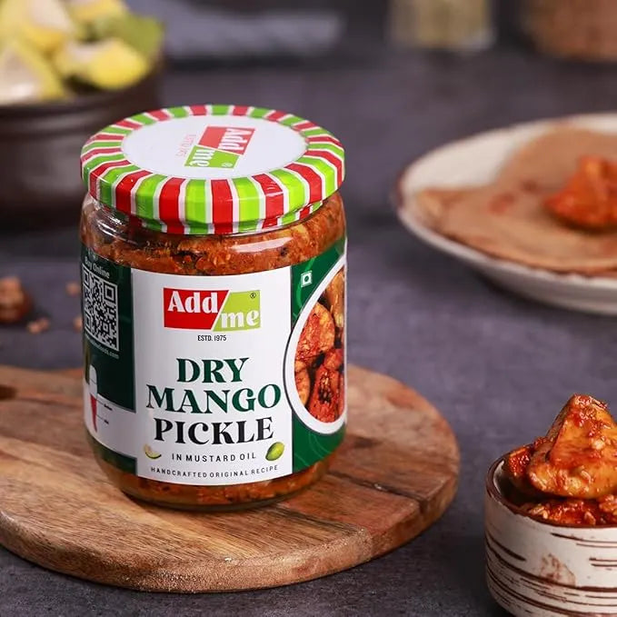 Jar of Add Me Dry Mango Pickle on a wooden board with a blurred background.mango pickle, sukha aam ka achar