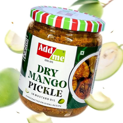 Jar of Add Me Dry Mango Pickle with mangoes in the background. mango pickle, sukha aam ka achar