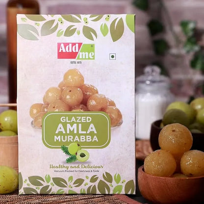 Packaging of Add Me Glazed Amla Murabba with a close-up of amla fruits in the foreground.