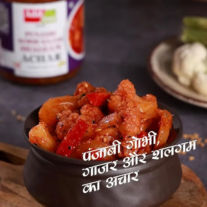 Spicy dish in a bowl with text overlay on a dark background. punjabi mix achar