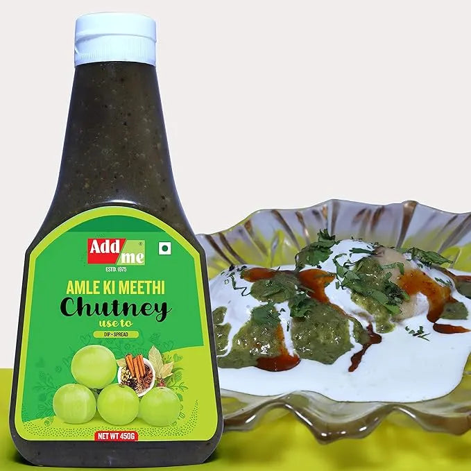 Bottle of Adda Amla Ki Meethi Chutney with a plate of chutney on a light background