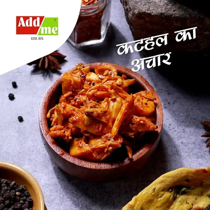 Wooden bowl of a spicy dish with spices and Addme logo on a dark background