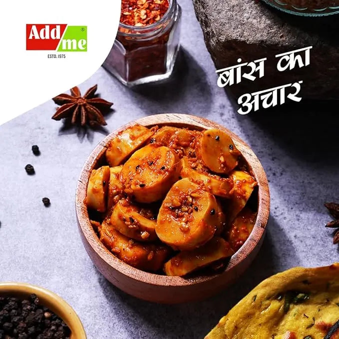 Wooden bowl of pickled vegetables with spices and Addme branding on a gray surface.