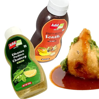 Add Me Foods: Three bottles of Adda brand chutneys with a samosa dipped in a red sauce on a white background.