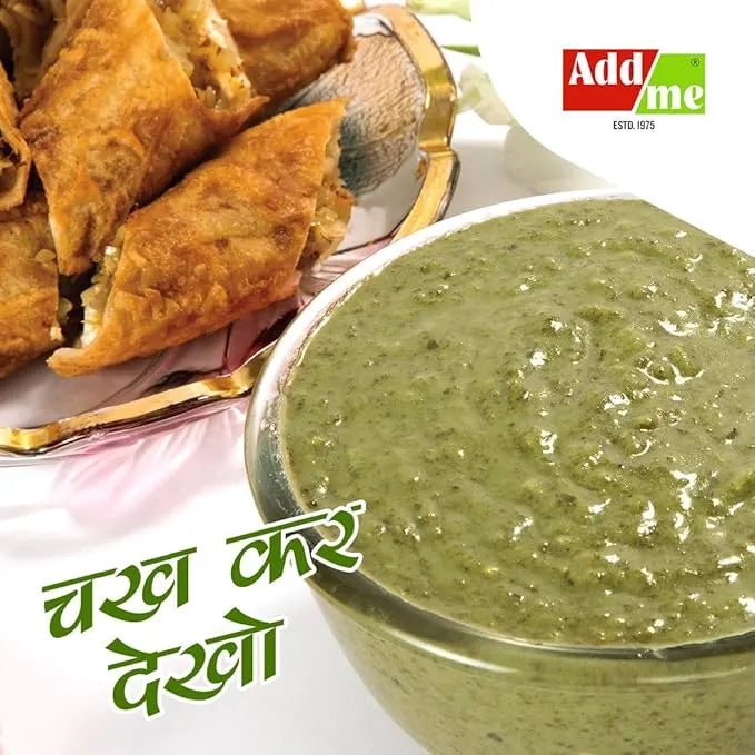 Bowl of green chutney with fried samosas on a white background, featuring the Addme brand.