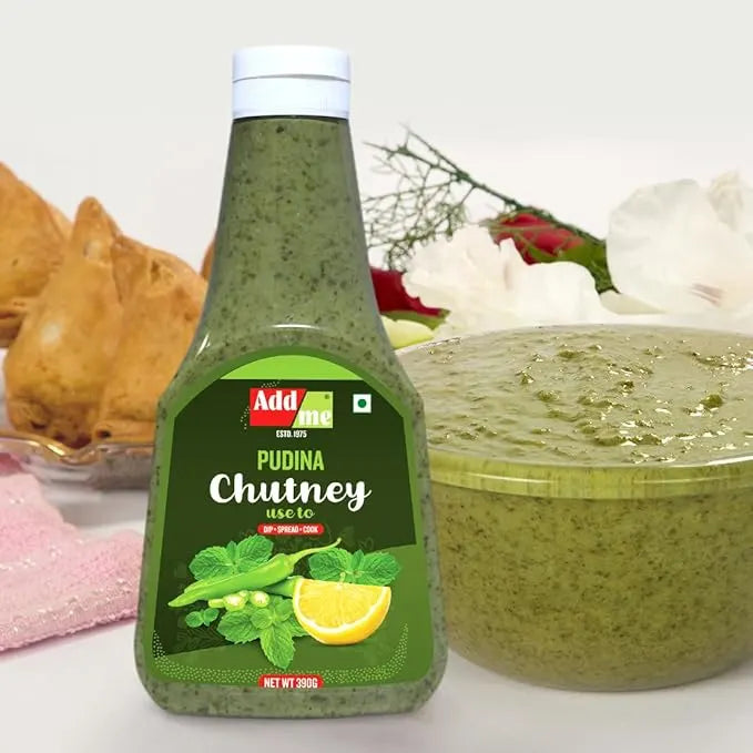 Bottle of Adda Pudina Chutney with a bowl of chutney and snacks in the background