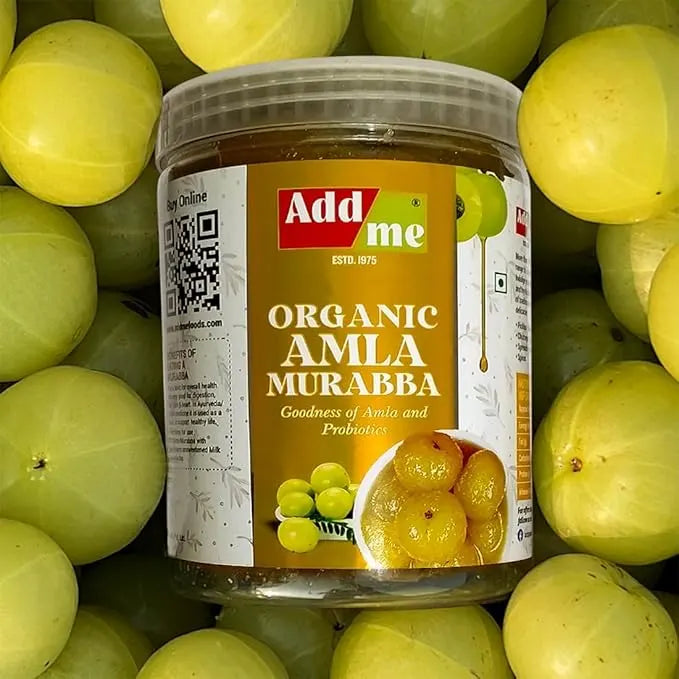 Jar of Add Me Organic Amla Murabba surrounded by green amla fruits
