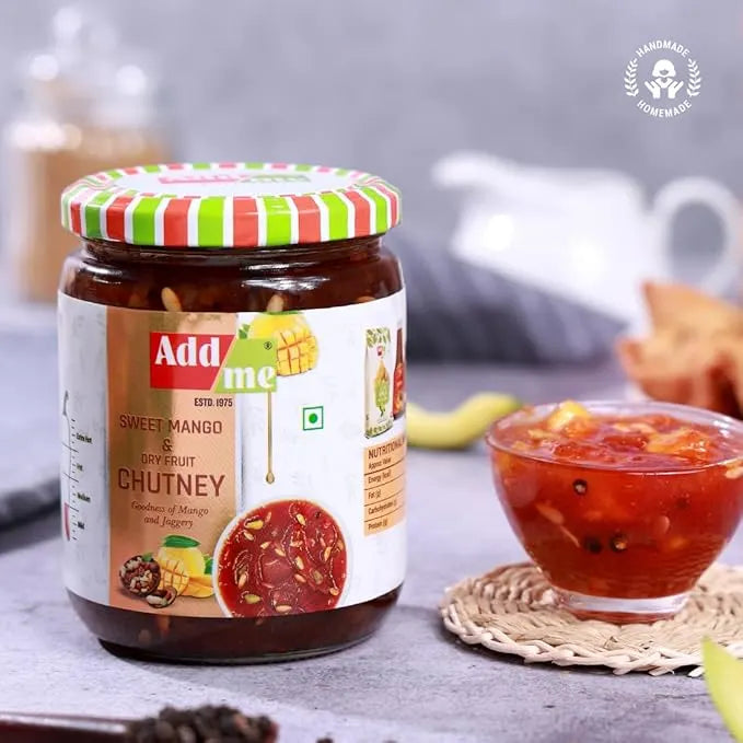Jar of Add me Sweet Mango & Citrus Chutney with a striped lid on a table.