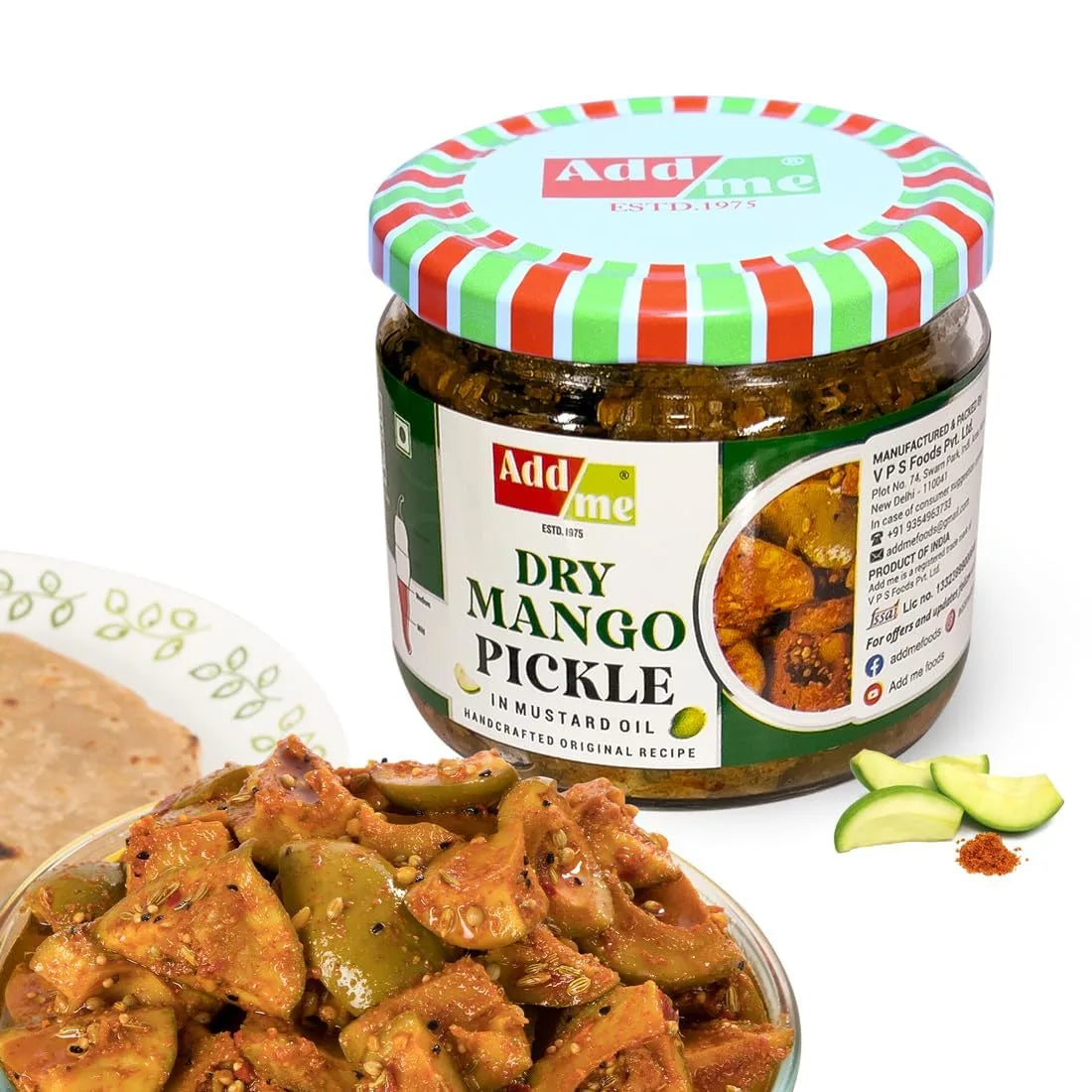 Jar of Add me Dry Mango Pickle with a bowl of pickles and mango slices on a white background