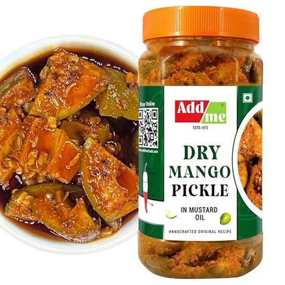 Jar of dry mango pickle with a label and a bowl of pickled vegetables.