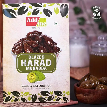 Add Me Foods: Packaging of Add Me Glazed Harad Murabba with a bowl of dried fruits in the background.