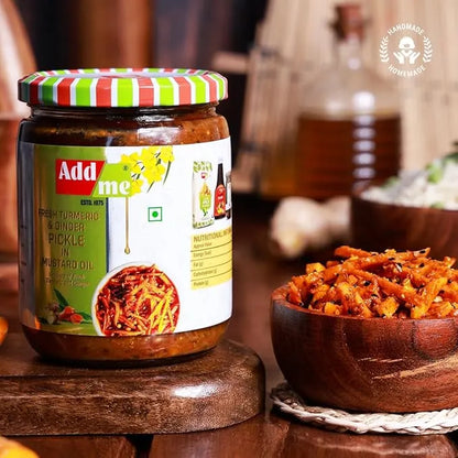 Jar of Add Me Turmeric and Ginger Pickle with a striped lid on a wooden surface, next to a bowl of pickles.