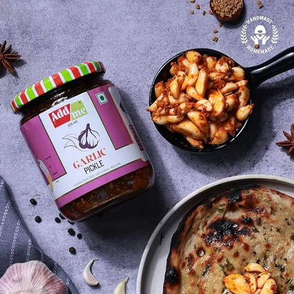 Add Me Foods: Jar of Add me Garlic Pickle with a bowl of food and flatbread on a gray surface.