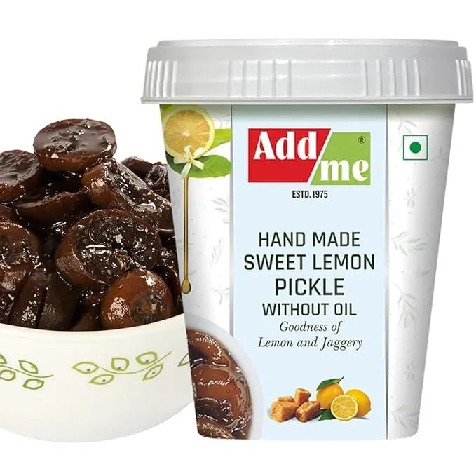 Container of Add Me sweet lemon pickle with a bowl of dark brown pickles on a white background
