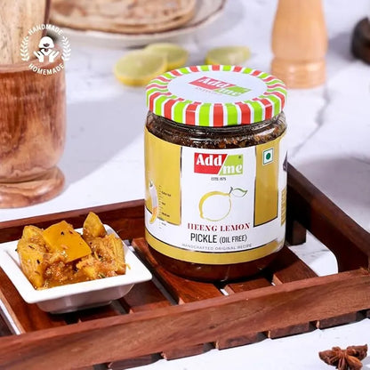 Jar of Add Me Hneyg Lemon Pickle on a wooden tray with a small bowl of pickled lemon pieces.