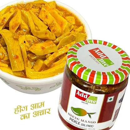 Bowl of hing mango pickle with Adda Me jar on a white background