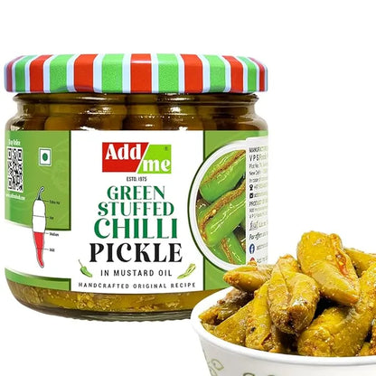 Jar of Add Me green stuffed chilli pickle with a bowl of pickles on a white background
