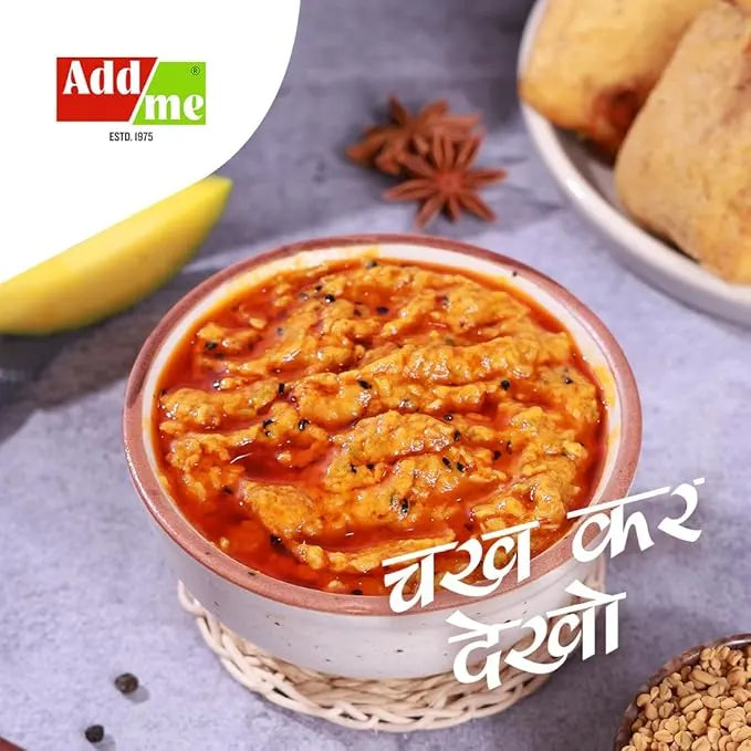 Bowl of chole (chickpea curry) with spices and a banana on a gray surface, featuring Addme logo.