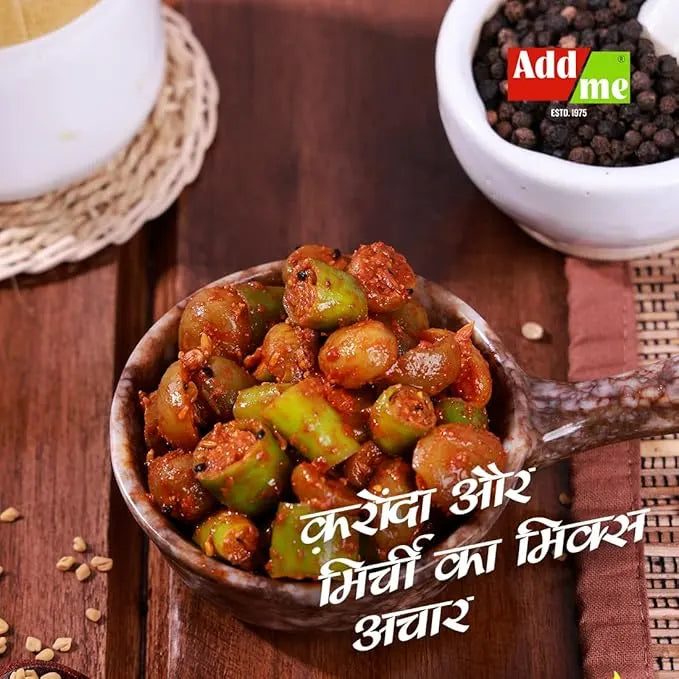 Serving of okra and green chili chutney in a wooden spoon on a wooden surface with 'Add Me' branding.